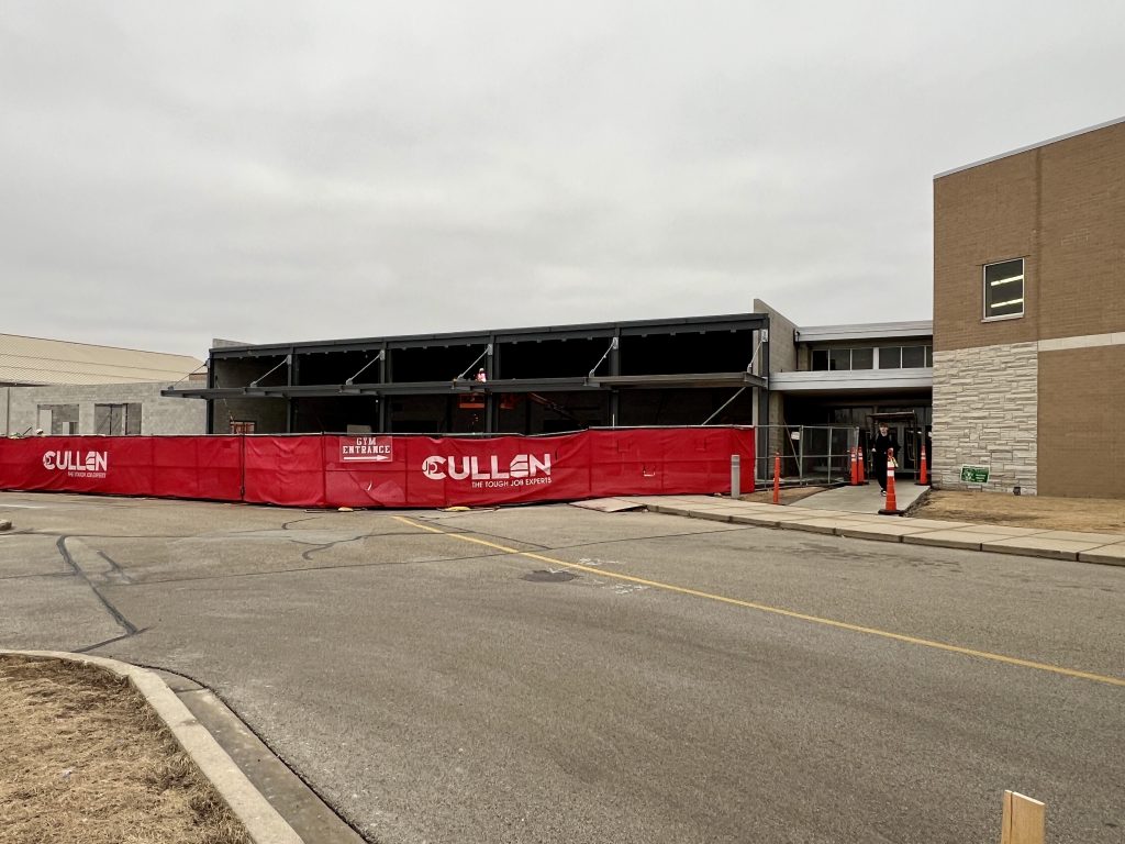 outside incomplete cafeteria with steel structure visible. march 4, 2025
