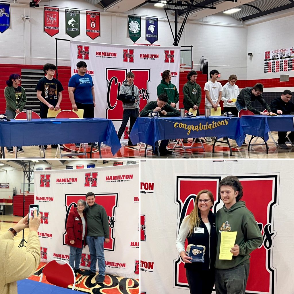 Students signing dual enrollment academy letters.