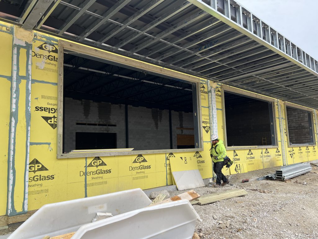 outside incomplete cafeteria with exterior sheathing visibile. April 4, 2025