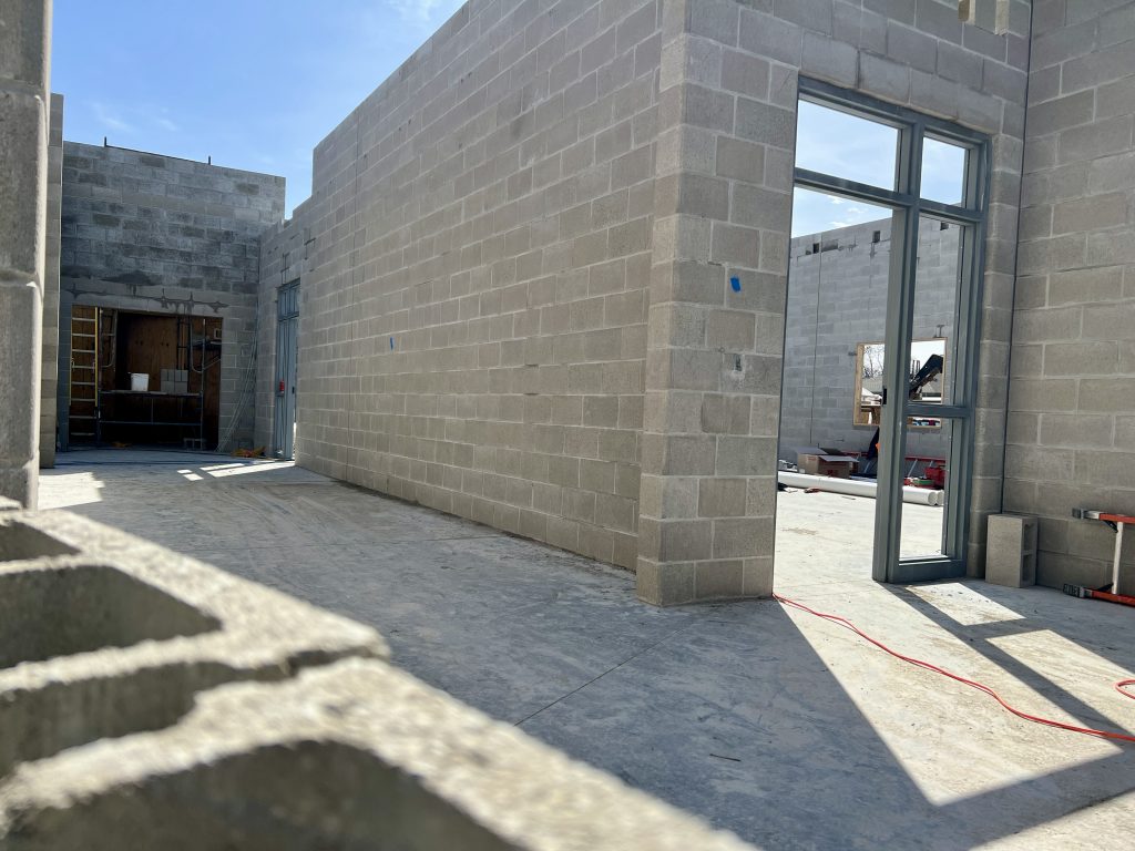 inside incomplete lannon elementary addition. no roof. walls partially complete. concrete bricks visible throughout. April 4, 2025.