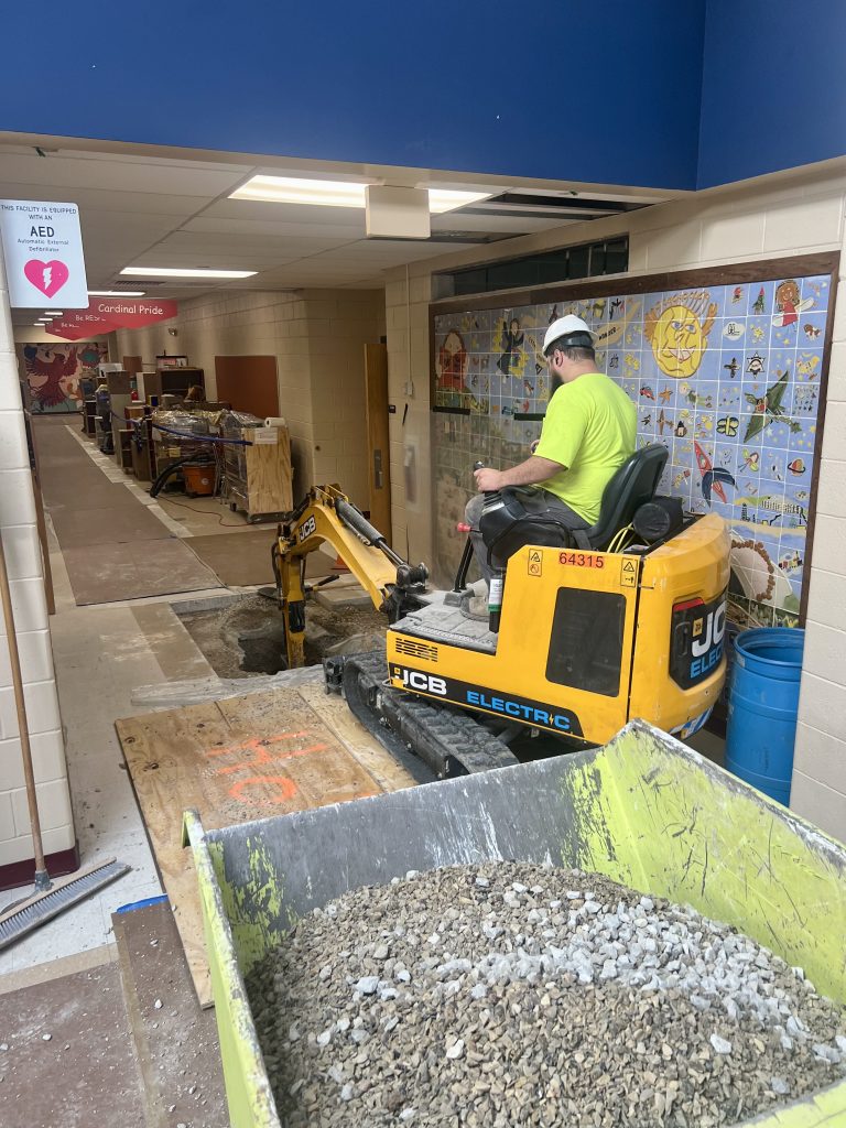 lannon hallway under renovation. construction equipment is digging in building floor.