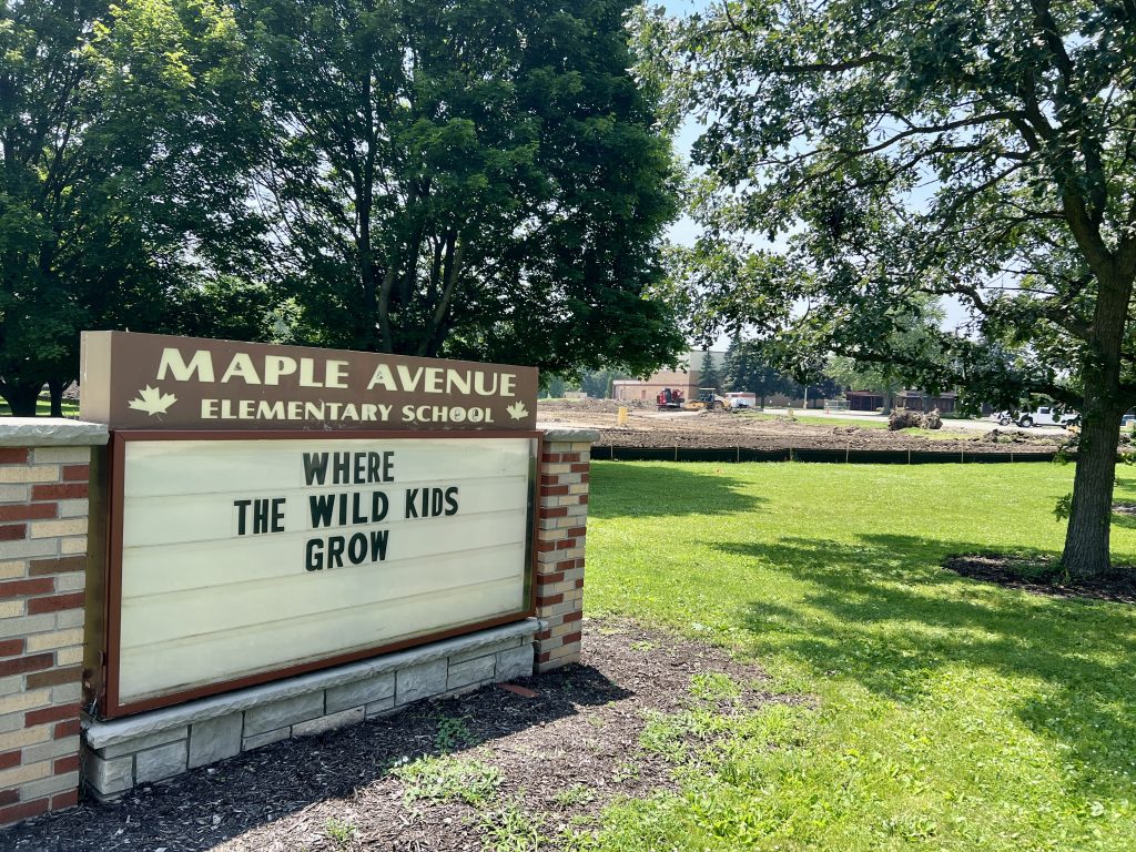 Maple Avenue Elementary School Sign that says where the wild kids grow. Construction visible in the background.