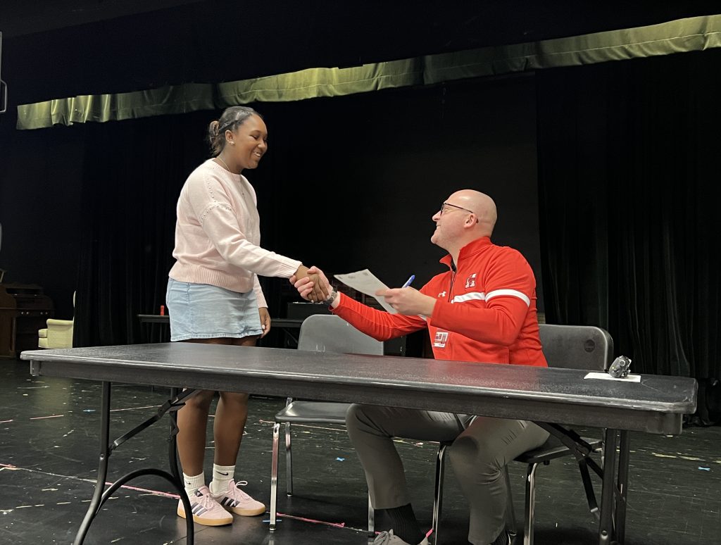 Student shaking the principals hand